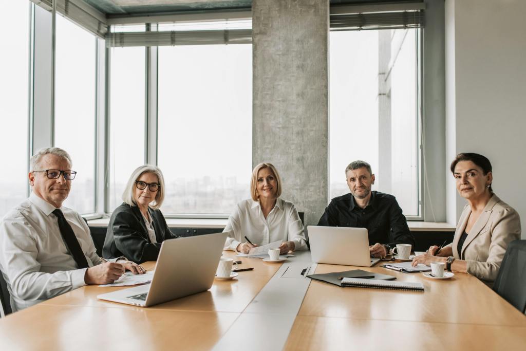Five people in a meeting - BAM Group (business consulting services) (services)