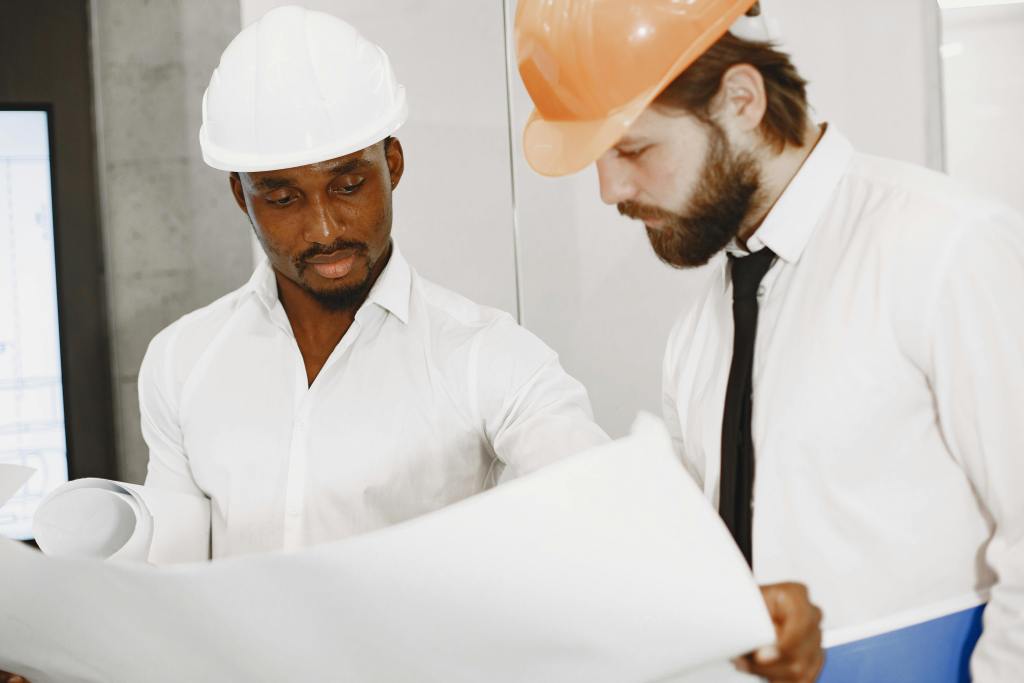 Engineers review blueprints - BAM Group (real estate development consulting) (contact)