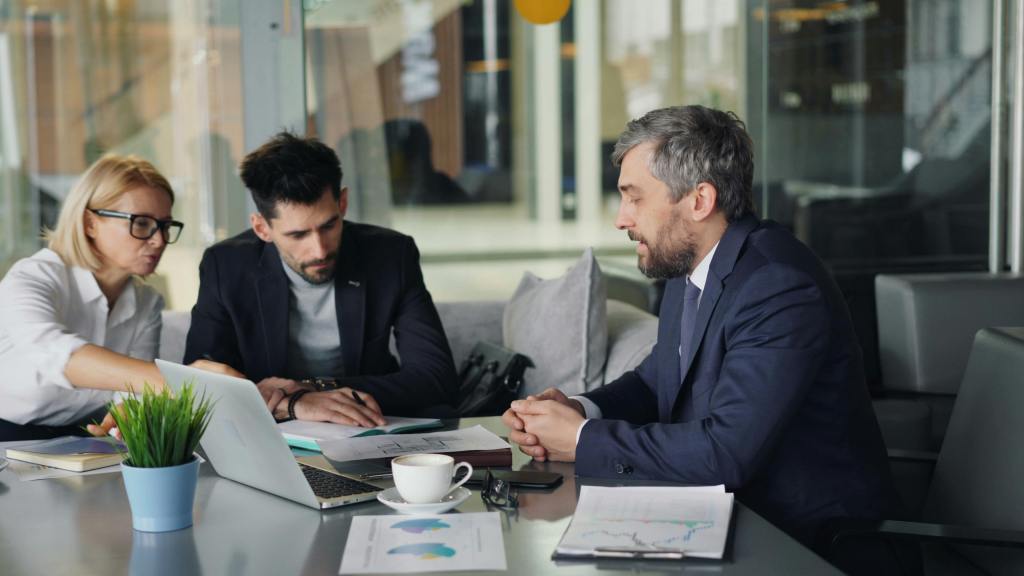 Three people in a meeting room - BAM Group